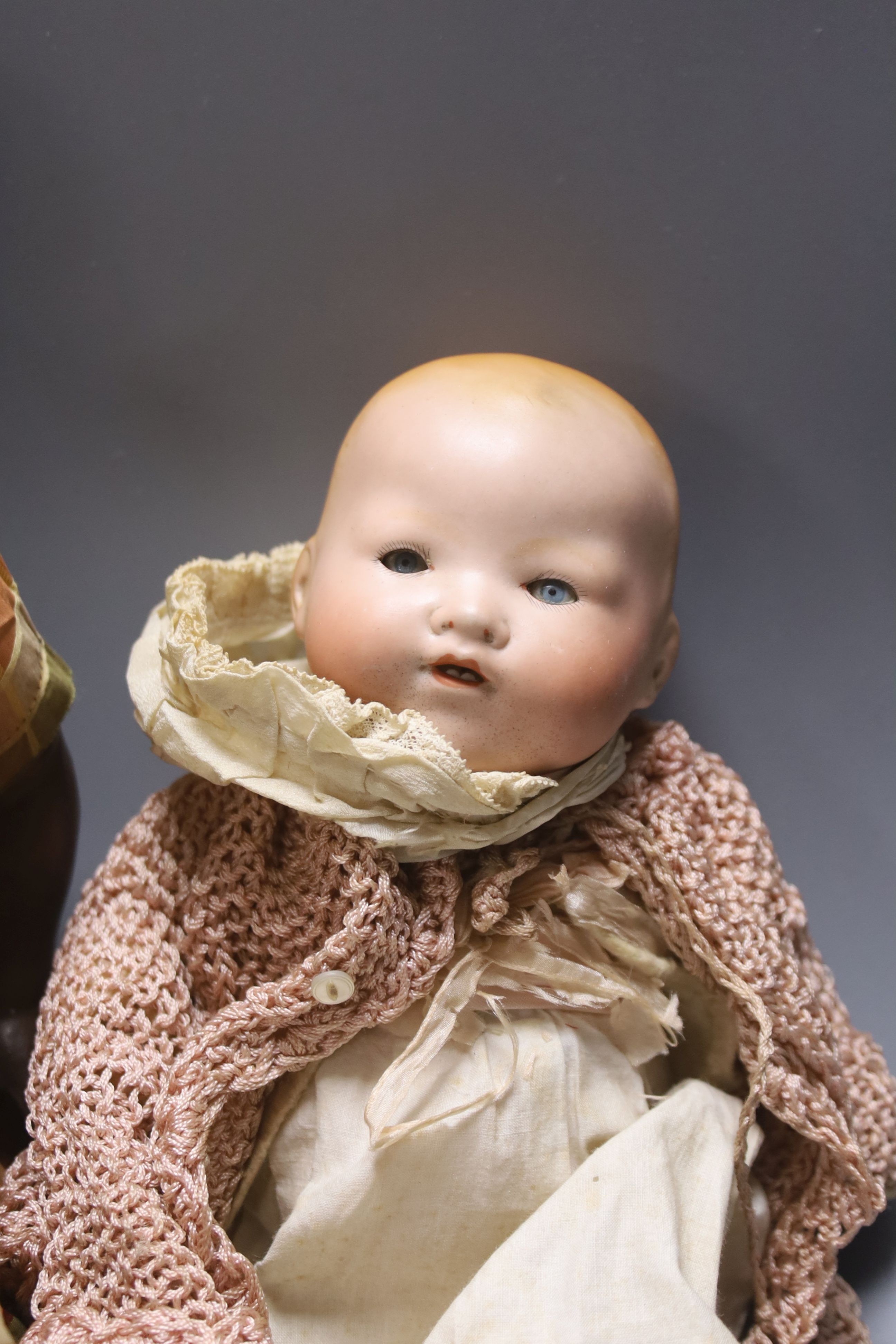 A black bisque-headed doll, German KB-M 5 bent limb with a smaller German bisque open mouth kid leather body doll and an AM Dream baby 351 with open mouth